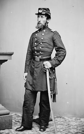 Photo of Colonel Breed Noyes Hyde of the 3rd Vermont Infantry. He stands in uniform, left hand on the hilt of his sword.